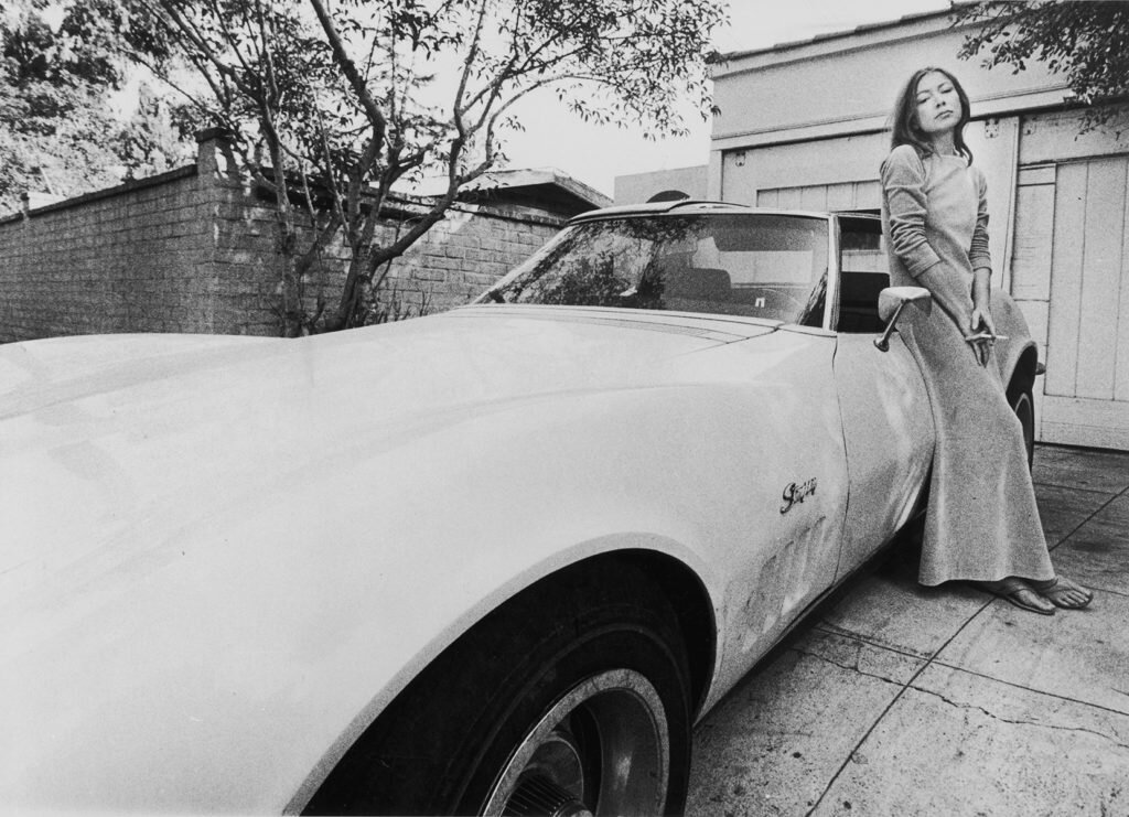 Subject: Author Joan Didion with her Corvette. 1971 Photographer- Julian Wasser Time Inc Not Owned Merlin-1381191